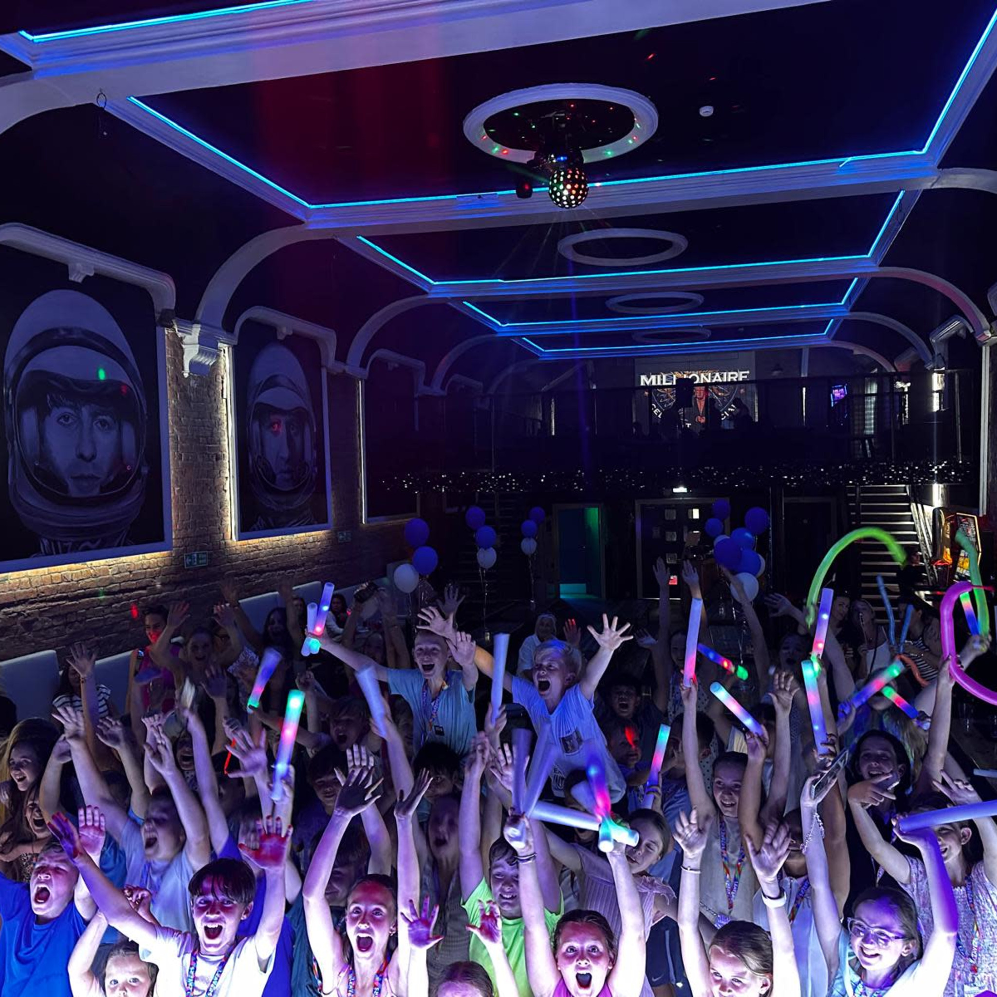 Guests celebrating under the hall's blue lights